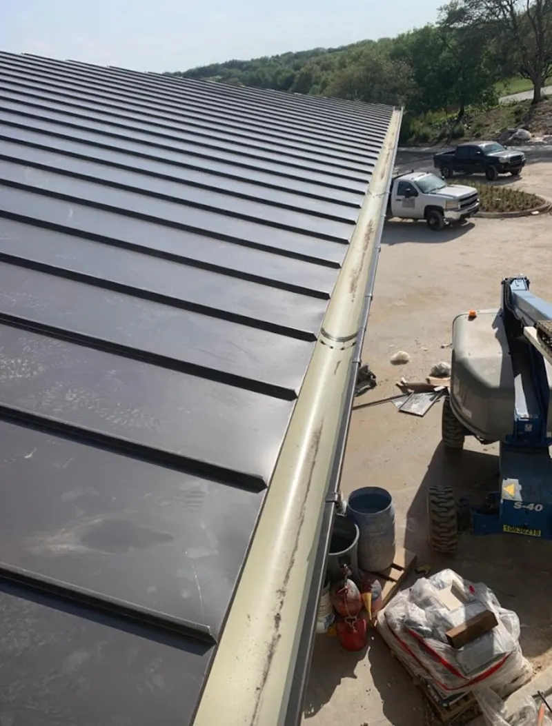 Standing seam panel and gutter detail on a metal roofing jobsite in Millville